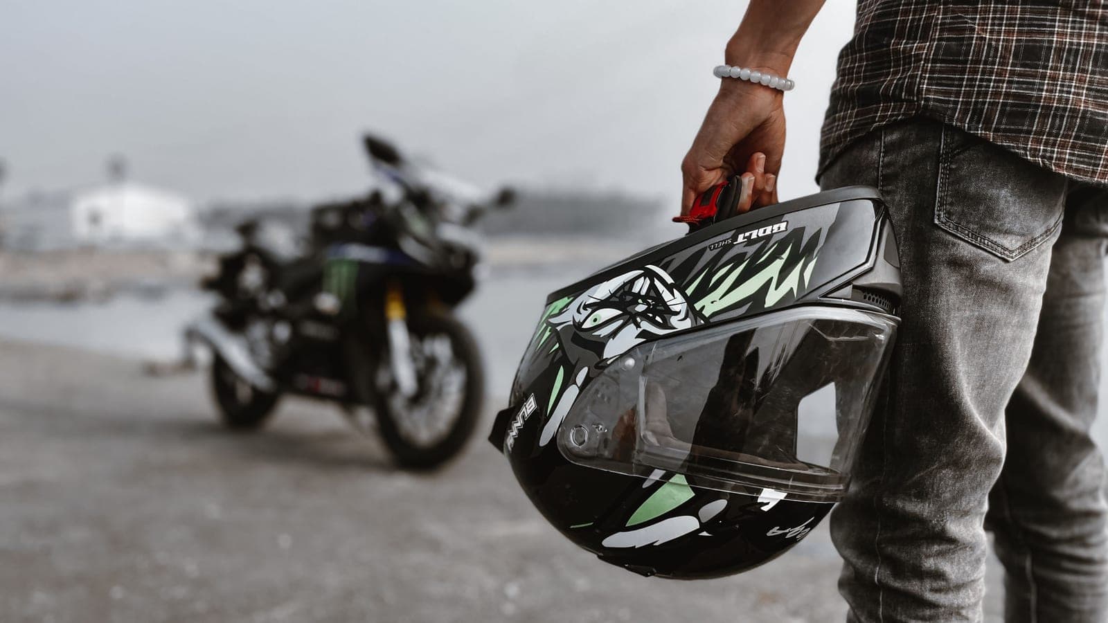 Rider measuring head size before choosing a motorcycle helmet
